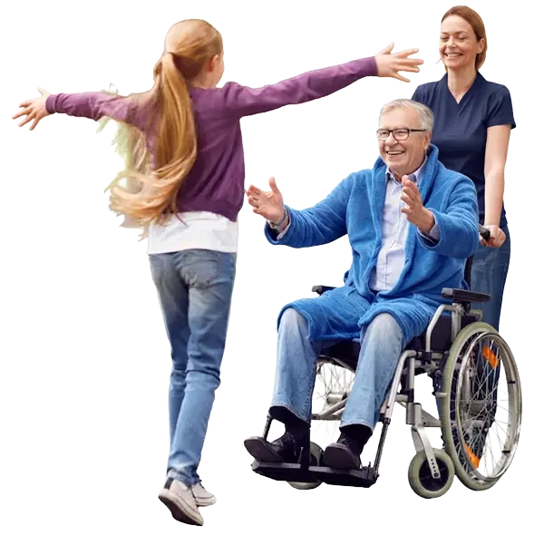 A young girl running with open arms towards her grandfather, who is seated in a wheelchair beside his carer